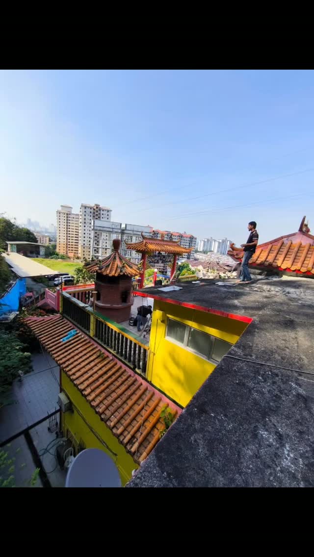 Rooftop electrical work with city skyline
