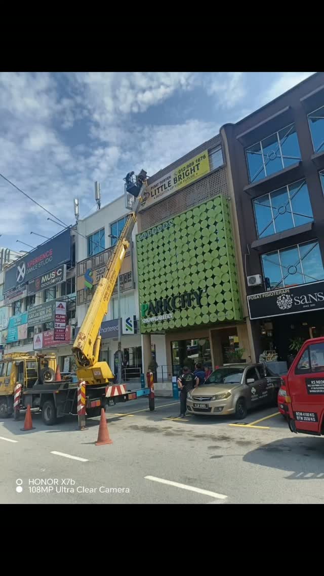 Boom lift servicing commercial signage